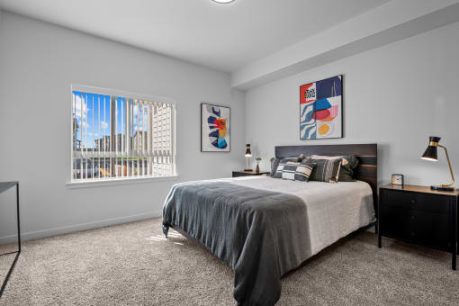 a bedroom with a bed and a large window