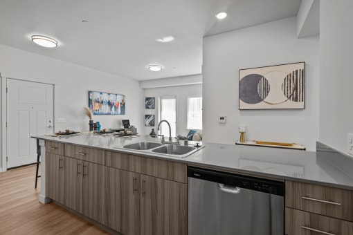 an open kitchen with a large counter top and a sink