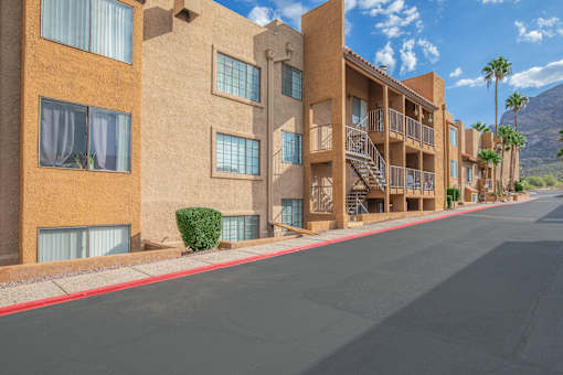 A street view of a residential area with apartment buildings.