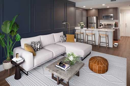 A modern living room with a white sofa and a coffee table.