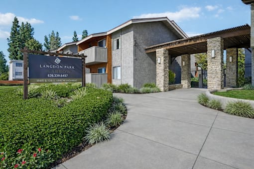 The image shows a sign for Langbon Park Apartments with a phone number on it.