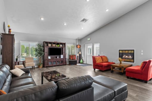 the living room has a fireplace and leather couches