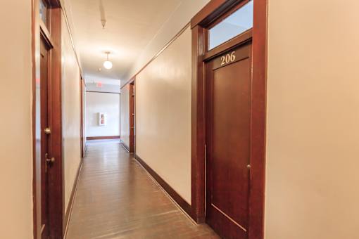 A hallway with a door numbered 206.