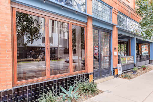 A building with a brick facade and a blue trim.