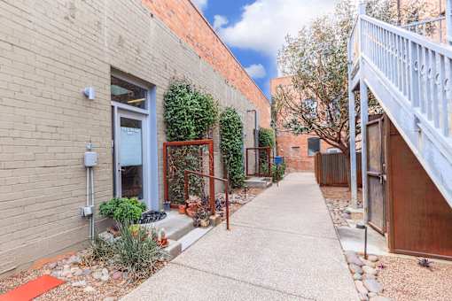 A small alley with a red mat on the ground.