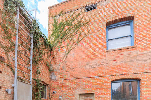 A red brick building with a window and a door.