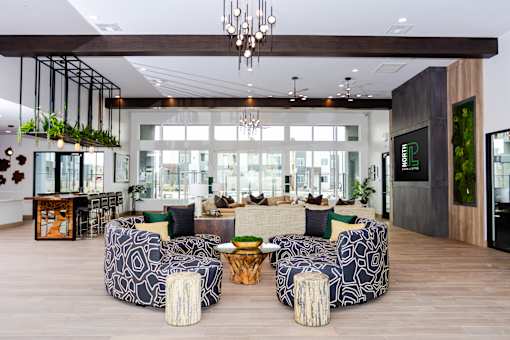 A modern living room with a large sofa and a chandelier.