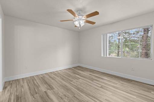 A room with a ceiling fan and a window.