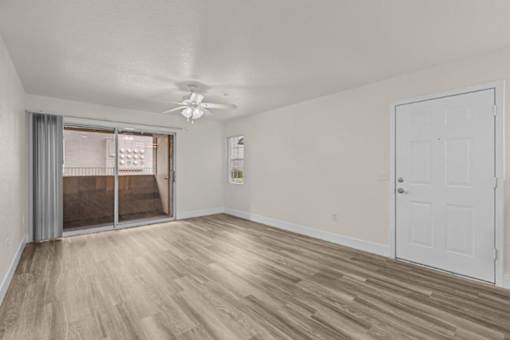 A room with a sliding glass door and a white door.