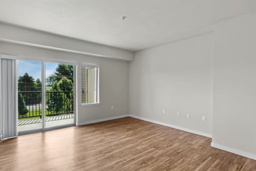 a bedroom with a sliding glass door and hardwood floors