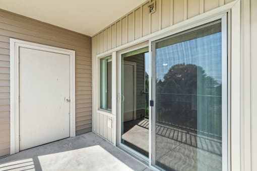 a large sliding glass door leading to a balcony