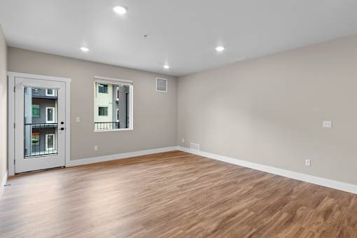 a bedroom with a hardwood floor and grey walls