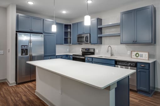 a kitchen with blue cabinets and a white island