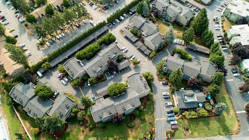 A bird's eye view of a residential area with houses and cars.