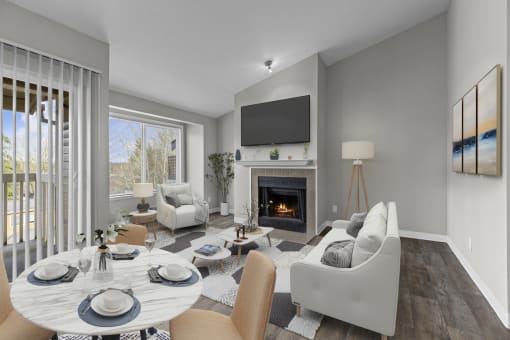 a living room with a fireplace and a table and chairs