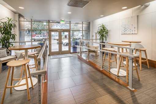 A view of a cafeteria with tables and chairs.