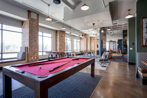 a pool table in the resident clubhouse at the bradley braddock road station apartments