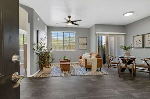 A living room with a ceiling fan and a couch.