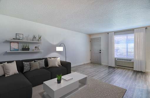 Oasis at 2600 a living room with a black couch and a white coffee table