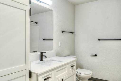 Oasis at 2600 Bathroom with sink, cabinet and mirror.