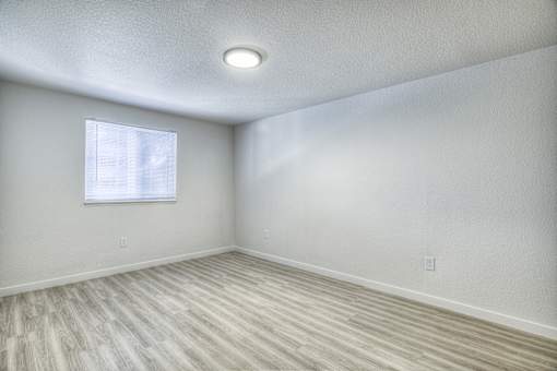 Oasis at 2600 an empty room with wood flooring and a window