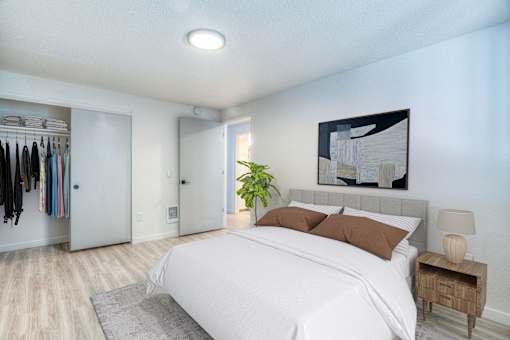 Oasis at 2600 Bedroom with bed and art above headboard