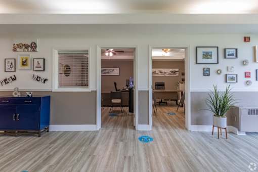 A room with a blue cabinet and a white fridge.
