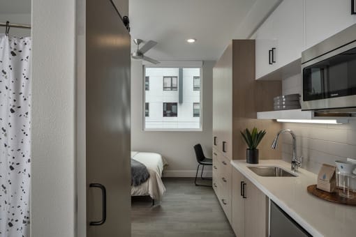 a bedroom with a large window in a 555 waverly unit