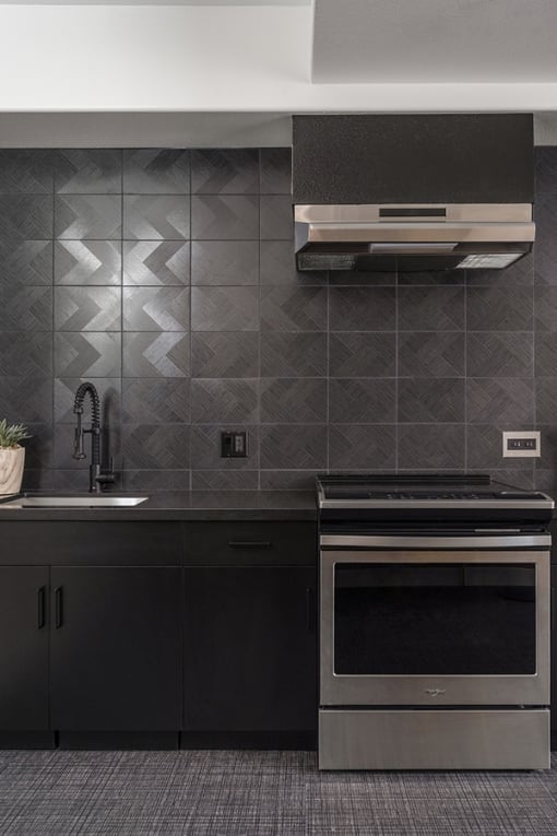 a kitchen with a stove top oven next to a sink
