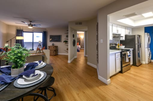 an open kitchen and living room with a dining room table