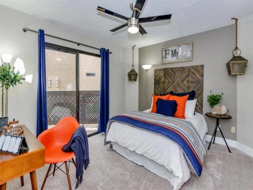 a bedroom with a bed and a ceiling fan