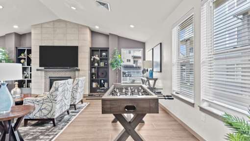 A modern living room with a fireplace and a television.