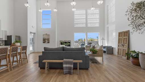 a living room with a gray couch and a dining room table