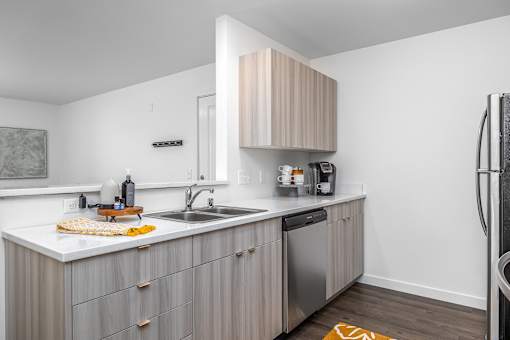 a small kitchen with a sink and a refrigerator