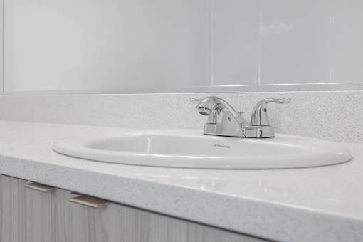 a white bathroom sink with a silver faucet