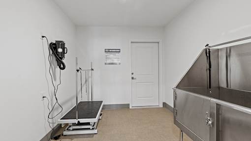 a room with a refrigerator and a treadmill and a door