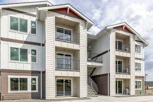 a row of town homes with stairs and balconies