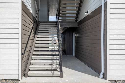 a set of stairs leading up to a building with a door