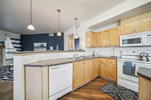 A kitchen with wooden cabinets and white appliances.