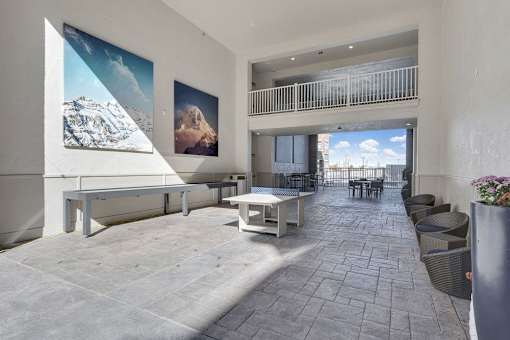 A spacious patio with a table and chairs.