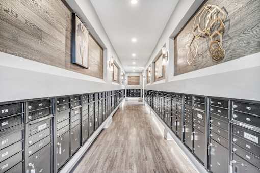 A long hallway with a series of drawers on the side and a wooden floor.