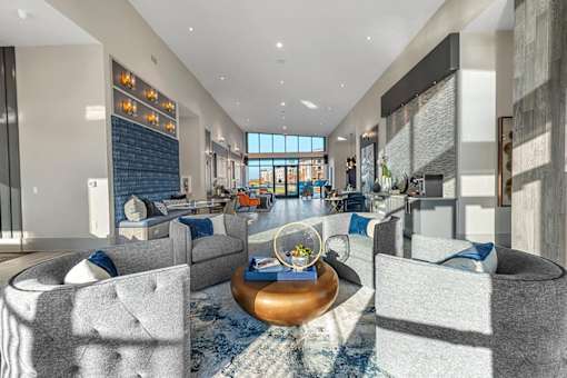 A modern living room with a large grey sofa and a coffee table.