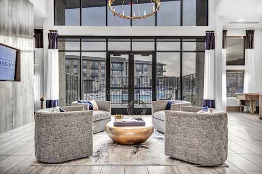 A modern living room with a fireplace and two grey couches.