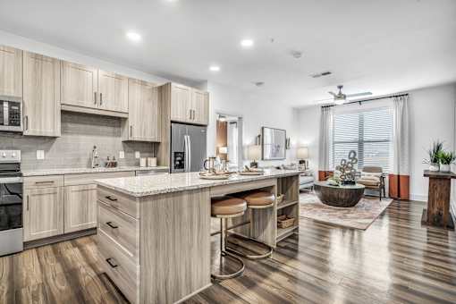 A modern kitchen with wooden cabinets and a central island.
