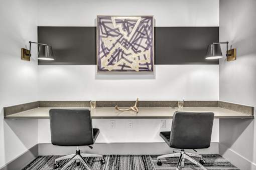 A modern office with a large abstract painting on the wall.