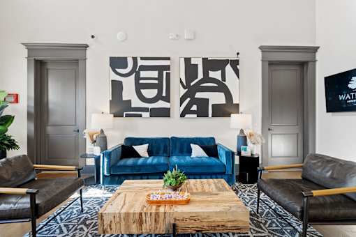 A living room with a blue couch and a wooden coffee table.