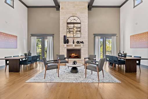 A living room with a fireplace and a dining table.