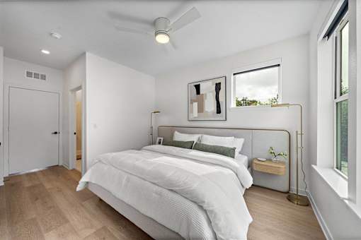 A bedroom with a large bed and a window.