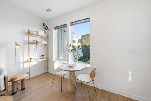 A white room with a table and chairs.