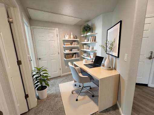 A room with a desk, chair, and bookshelf.